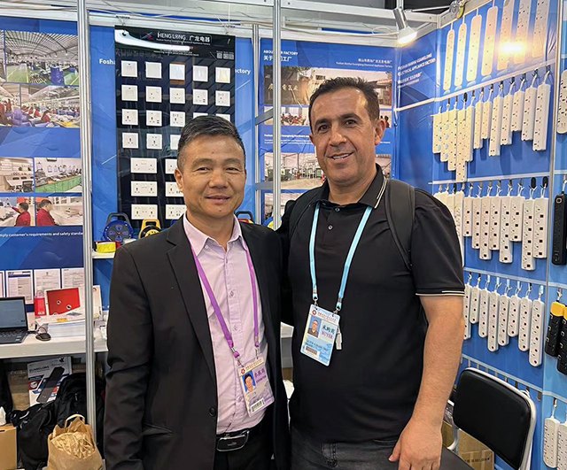 Guanglong team with a customer at the Canton Fair booth