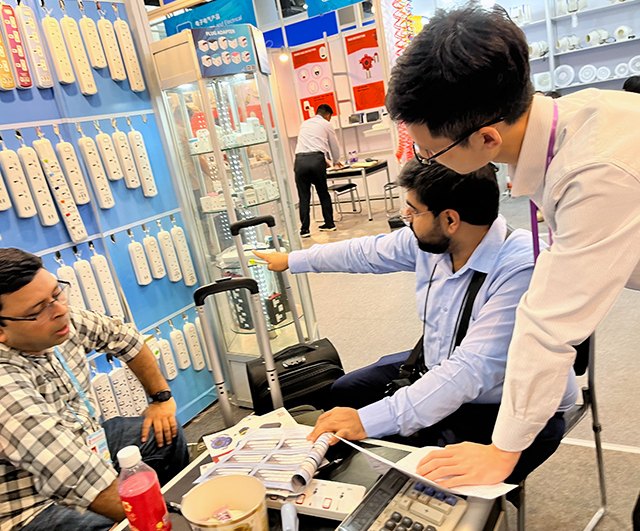 Showing the product catalogue at the Canton Fair booth
